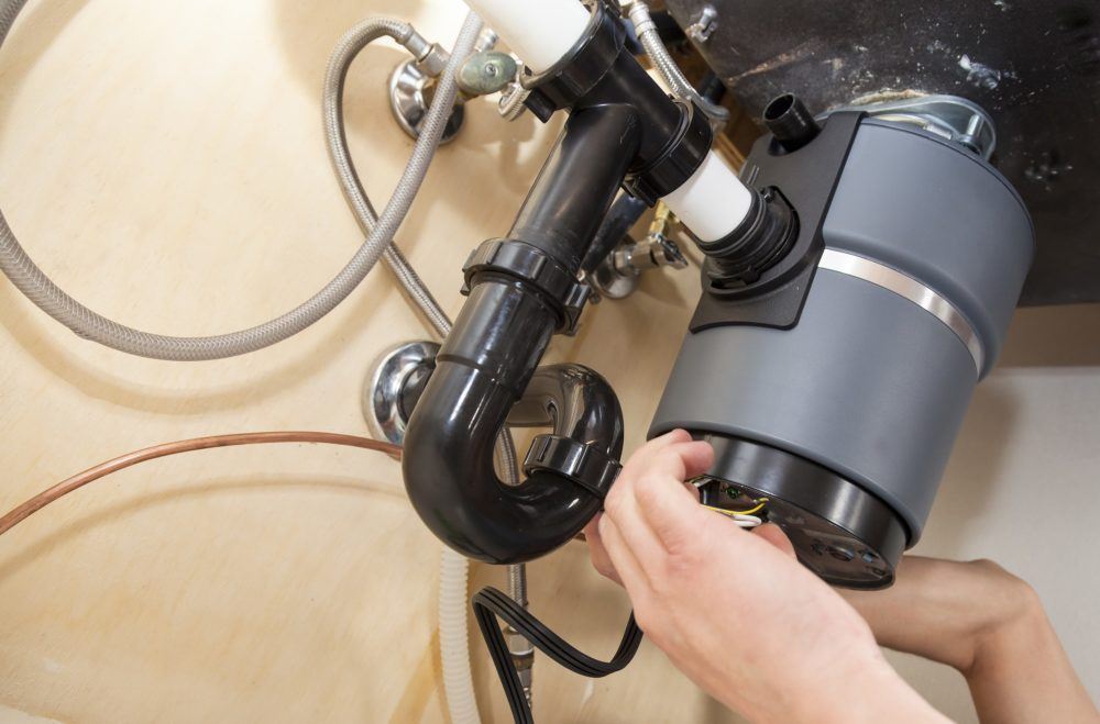 Plumber Installing Garbage Disposal in Residential Home near Wheeling, IL